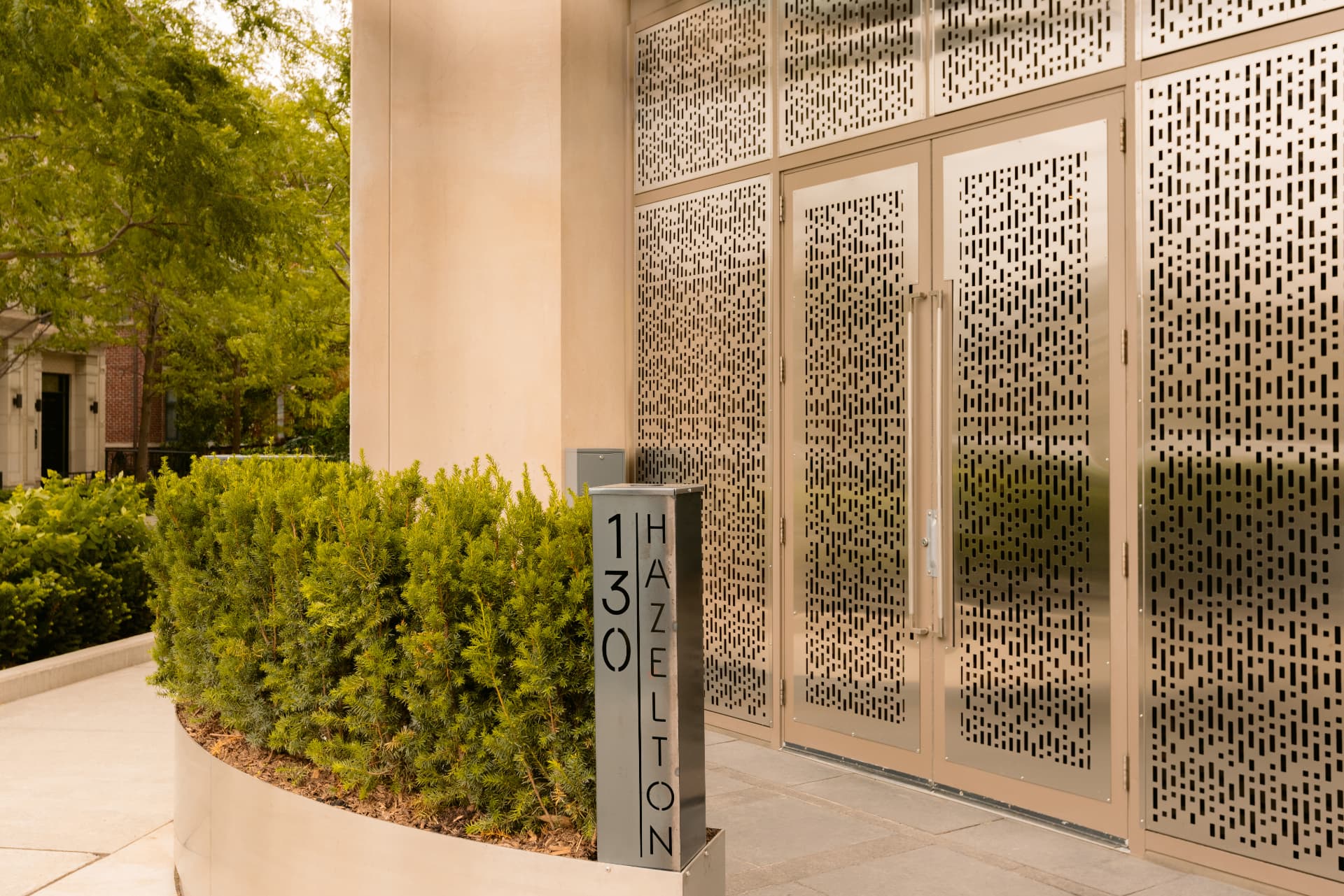The 130 Hazelton address plaque beside the Globacor entrance
