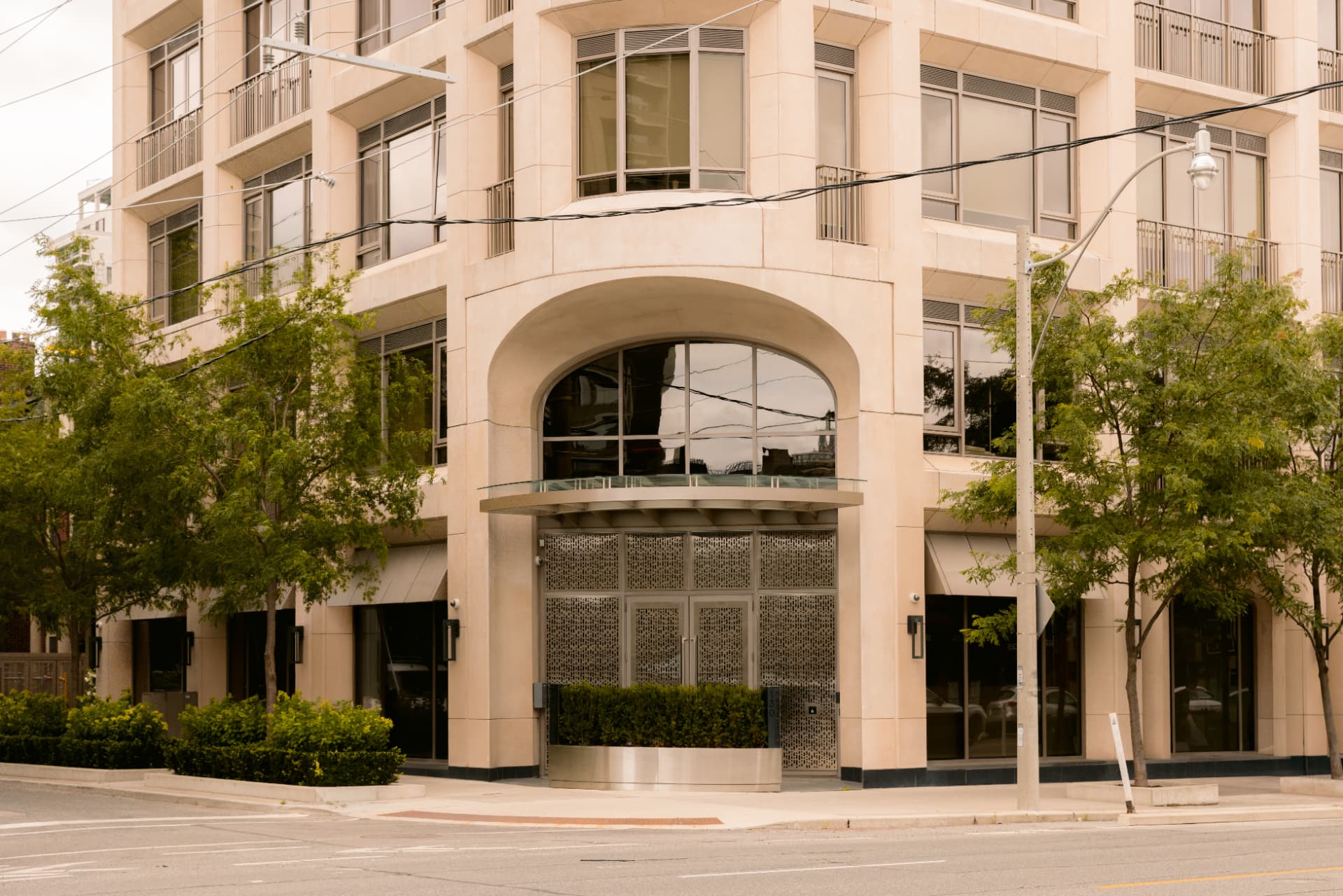 The arched perforated-steel entrance to Globacor Partners at 130 Hazelton Avenue